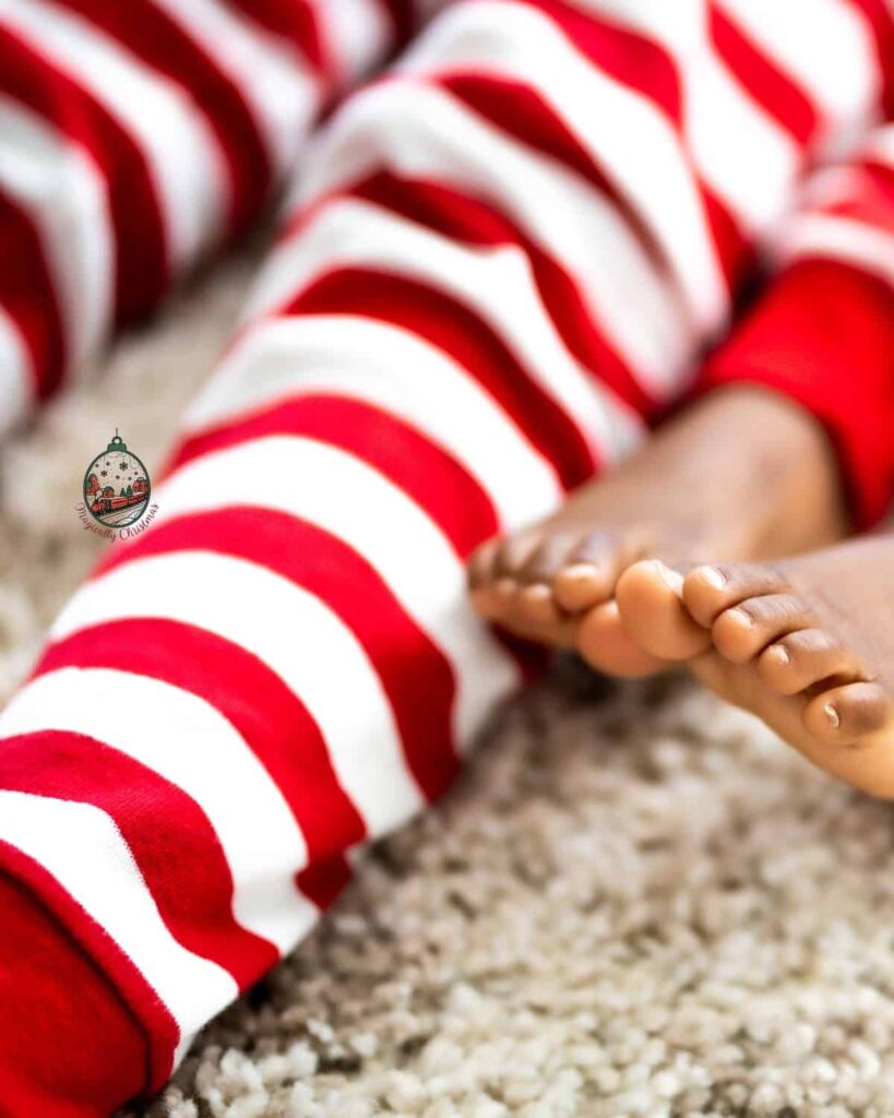 Close up of candy cane striped Christmas pajamas on kids.