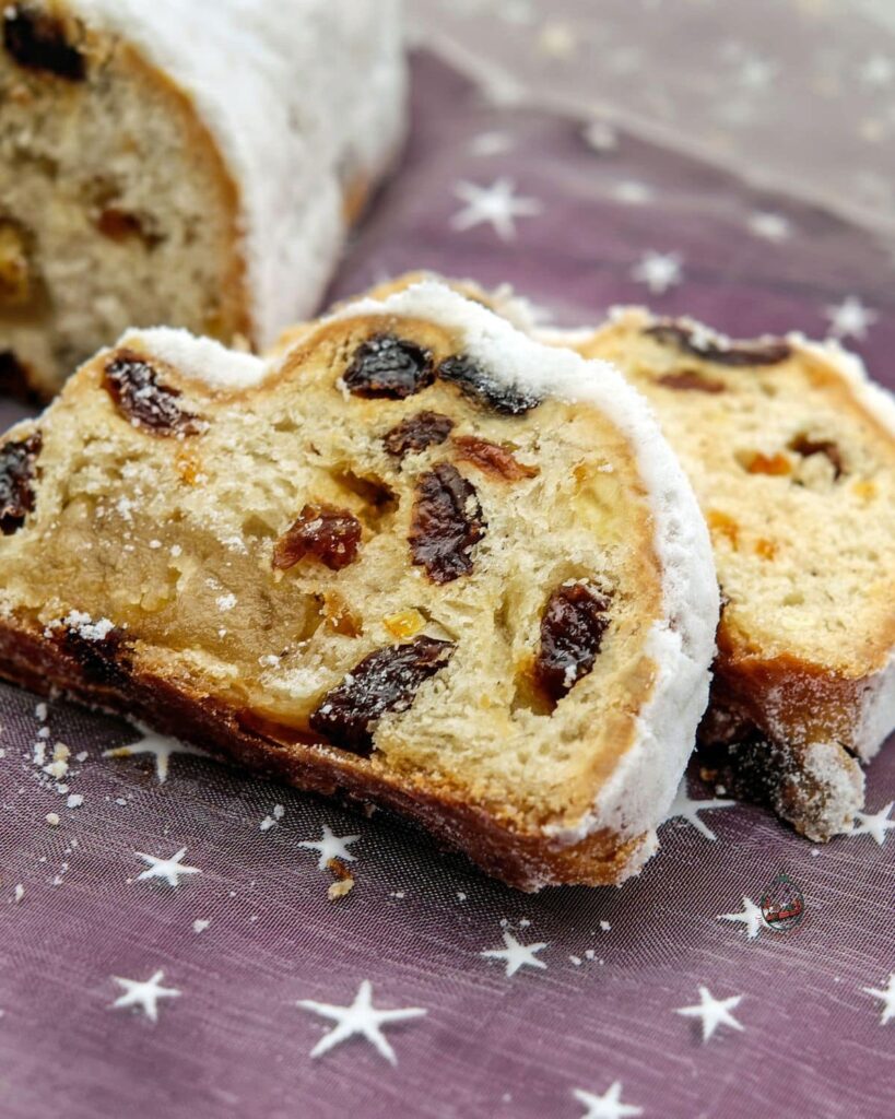 Slices of Christmas stollen with powdered sugar on top.