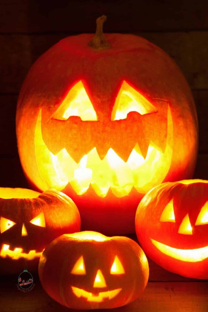 Close up of carved pumpkins that are glowing.