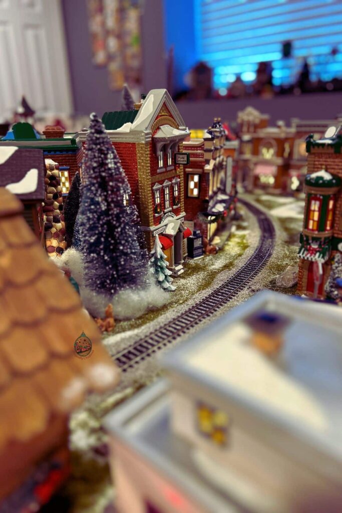 Looking around a curve in the Christmas village where the train tracks runs through.