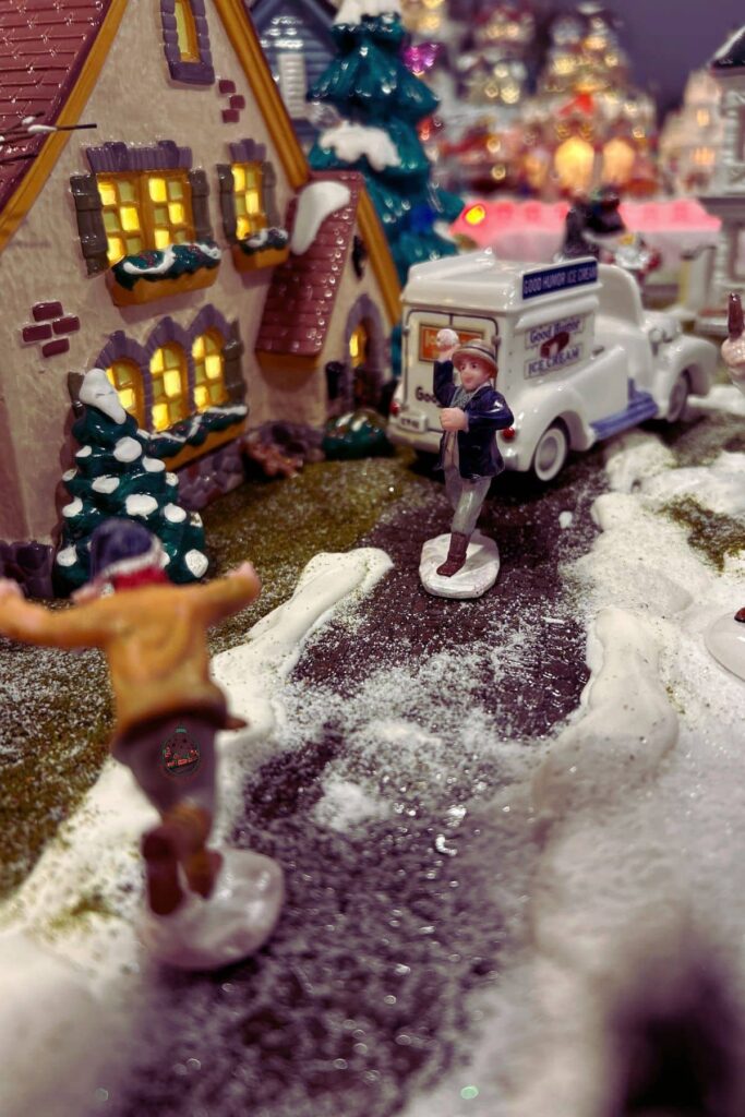 Figures of kids having a snowball fight on the Christmas village.